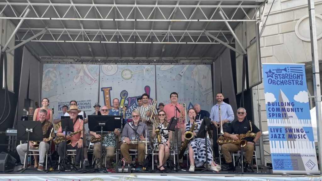 A photograph of the DC starlight orchestra posting on stage at a live performance. 
